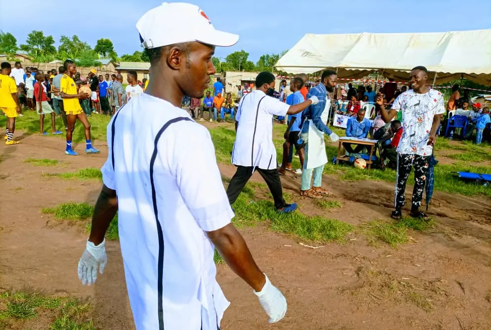 Volunteers and young people at an outdoor community sports event
